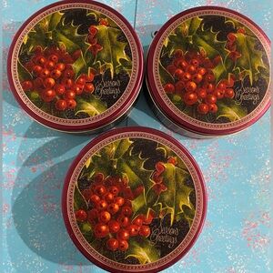 Three 7” x 2.5” Christmas cookie tins with lids.
